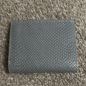 Brand new wallet, it’s gray snake skin style.